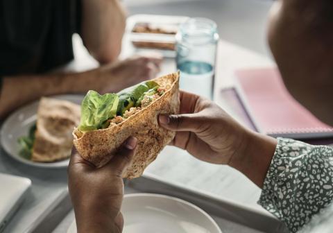 Student eats a healthy wrap