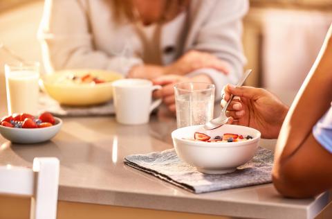 Two people eat breakfast together. 